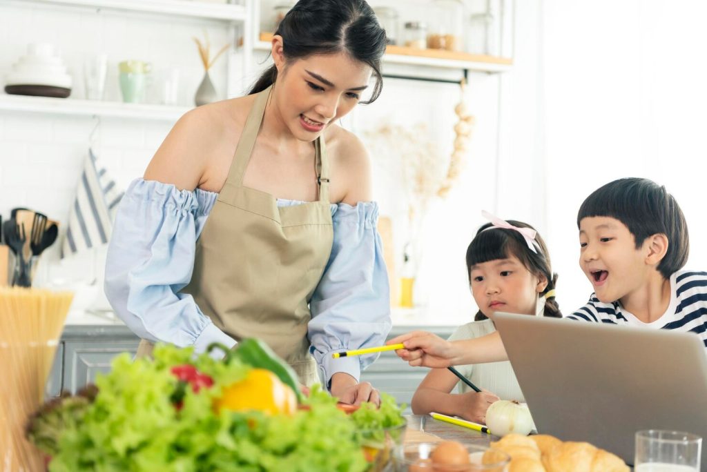 asian young single mother making food while taking care child kitchen 74952 2072