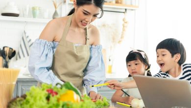 asian young single mother making food while taking care child kitchen 74952 2072