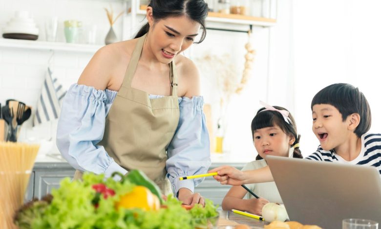 asian young single mother making food while taking care child kitchen 74952 2072