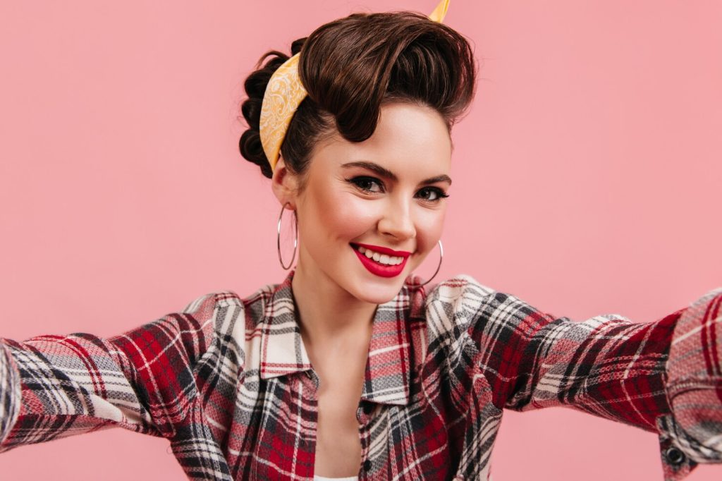 lovely young woman checkered shirt smiling pink background emotional pinup girl taking selfie 197531 13283