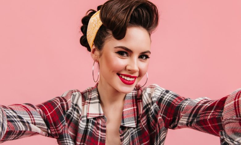 lovely young woman checkered shirt smiling pink background emotional pinup girl taking selfie 197531 13283